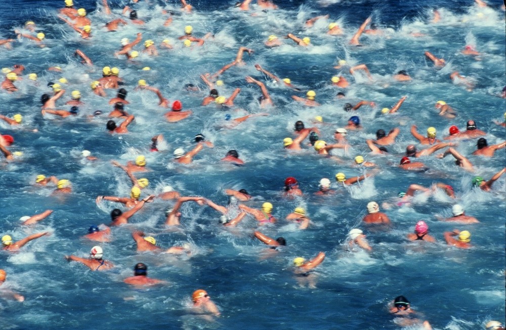 Swimmers compete in a triathlon.